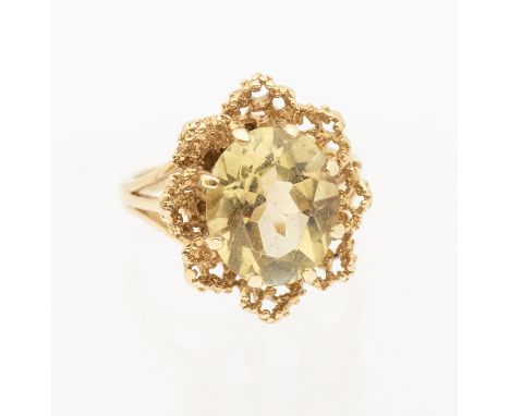 A vintage citrine and 9ct gold dress ring, set with an oval mixed cut citrine within a textured floral border, width approx 1