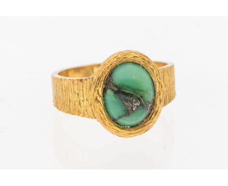 A turquoise 18ct gold ring, comprising an oval turquoise set to a bark textured band,width approx 13mm, size L1/2, total gros