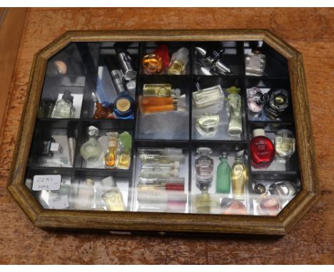 A collection of thirty-six miniature and sample perfume bottles, comprising vintage and later examples, including Chopard Wis