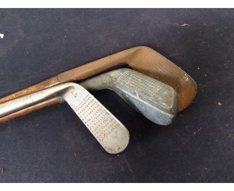 Three vintage golf clubs, early 20th Century, all with makers name.