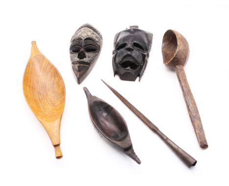A collection of African treen items to include masks, bowls and water spoon along with a spearhead.&nbsp;