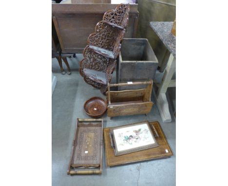 A carved wooden folding wall shelf, magazine rack, two trays, two inlaid plaques and a fruit bowl 