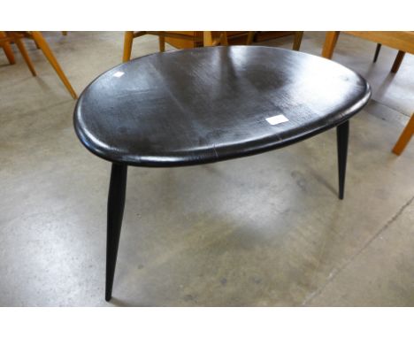 An Ercol black pebble shaped occasional table 