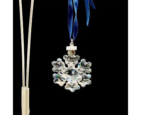 A beautiful clear snowflake with a blue ribbon and ï¿½1994ï¿½ etched on a metal tag. This item has its original box: 6"L x 5.