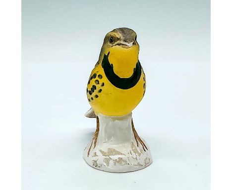 Handpainted matte yellow gray bird standing on a glossy white base. Goebel backstamp with embossed model number 3863206 Issue