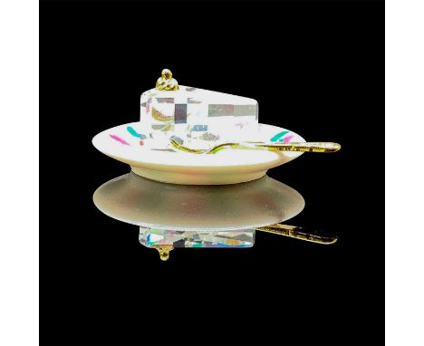 Small clear crystal slice of cake on a porcelain plate with a golden fork. Includes original box, 3.25"L x 2"W x 1.5"H. Issue