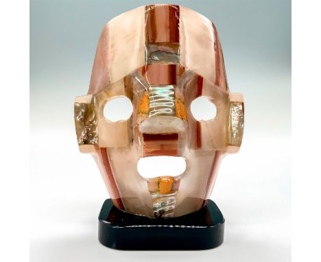 A figurine depicting an Aztec inspired mask made of red, white, and orange stone. Dimensions: 3.5"L x 1.75"W x 4.5"HCondition