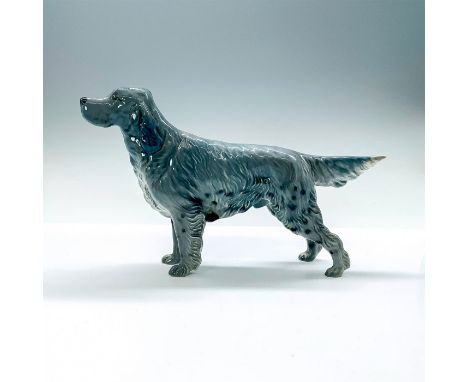 A ceramic figurine of a blue gray colored English setter dog standing on all four legs with his snout and tail pointed. Beswi