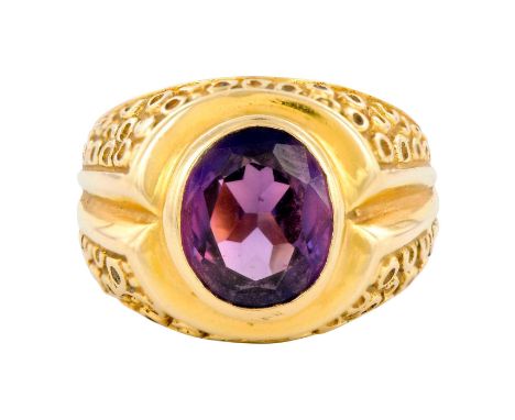 An impressive mid century ring with an oval purple sapphire. Weight 11.7 grams. Size 9.5. Marked 18K. Condition: Good, minor 