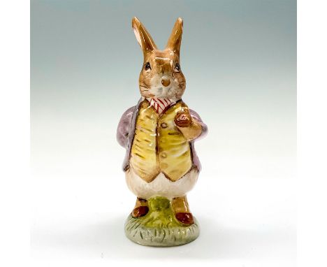 A figurine of a Benjamin Bunny wearing a purple coat and yellow vest while holding a Tobacco pipe. This item has its original