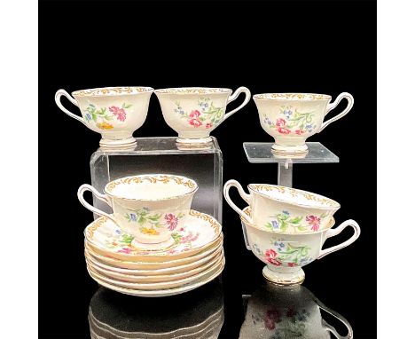 Six tea cups and six saucers in a lively colorful floral motif with gold rims and accents. Royal Albert backstamp. Tea cups 4