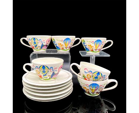 Six porcelain tea cups and six saucers in a colorful design of ladies at a fair with hot air balloons. Saucers 0.75"H x 6" di