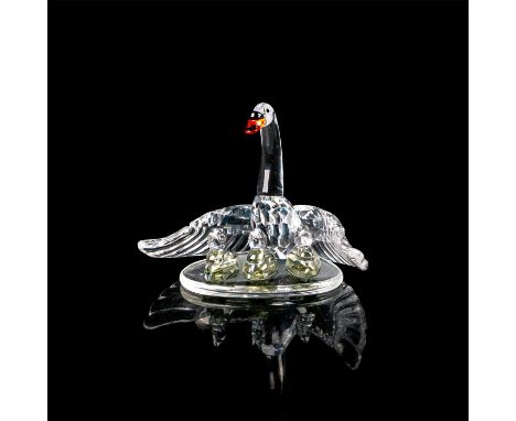 Family on clear base with mother swan extending wings for protection. Mother has red and black beak. 7550 NR 000 006. Swarovs