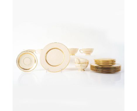 Beautiful gold rim, smooth trim. Cream colored with laurel pattern. Set includes 7 footed coffee cups, 7 saucers, and 7 bread