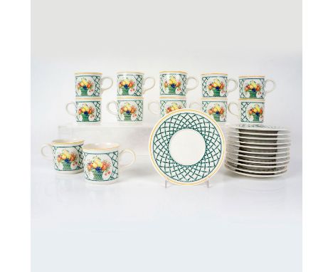 Twelve porcelain tea cups and twelve saucers in a vibrant green crisscross pattern with a basket of fruit in the center. Sauc