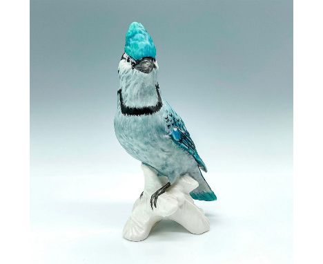 Details a blue bird with black and white detailing perched upon a white branch. Embossed with year and model number CV80. Goe