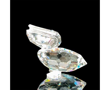 A clear faceted water bird with blue-green eyes. Swarovski mark. This item has its original box: 3.25"W x 2.5"H. Artist: Anto