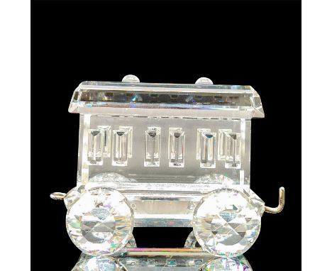 A clear figure of a train carriage. Swarovski mark. This item has its original box: 3.25"W x 3.5"H. Artist: Gabriele StameyIs