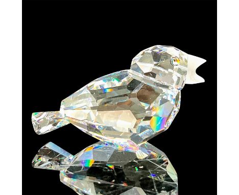 A clear faceted bird with tawny eyes and frosted beak. Swarovski mark. This item has its original box: 3.25"W x 2.5"H. Artist