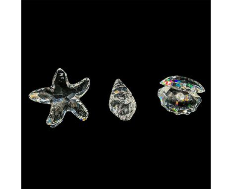 Set of 3 clear crystals: starfish, conch shell and clam. 7624 NR 100 000. This item has its original box: 5"L x 5"W x 4"H. Ce