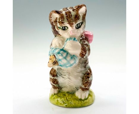 A figurine of Miss Moppet standing on her hind legs wearing a pink bow around her neck while playing with a mouse wrapped in 