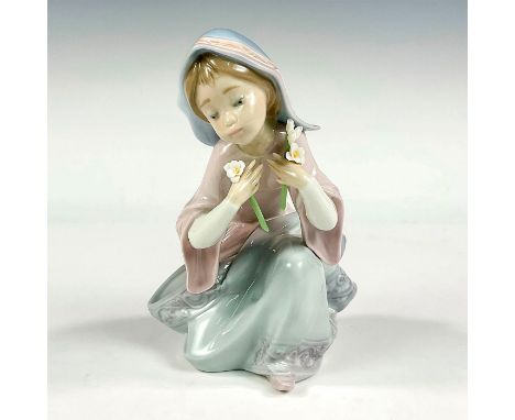 Glossy finish porcelain modeled as a young girl picking daisies. Lladro backstamp. Artist: Salvador DebonIssued: 1991-1994Dim