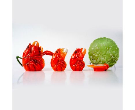 Porcelain figural set molded as lobster claw and head, including salt and pepper shakers, condiment dish, gravy boat with lad