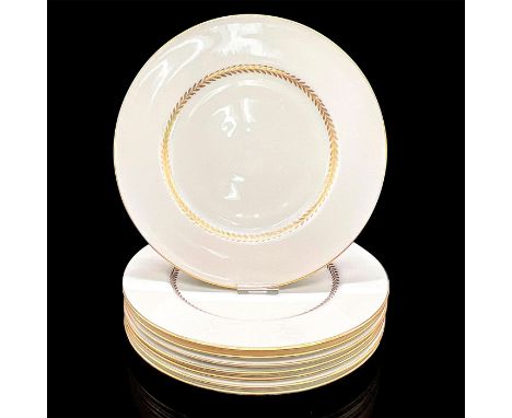 Eight cream colored plates with elegant gold scroll design and rim. Royal Doulton backstamp. Dimensions: 0.75"H x 10.5" diaMa