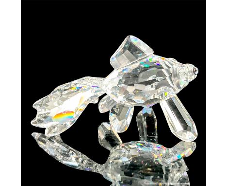 Depicts a clear crystal telescope fish standing on its fins with teal-colored eyes. This item has its original box. Dimension