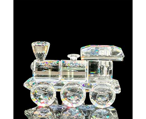 A clear faceted figure of front vehicle of the train. Swarovski mark. This item has its original box: 3.25"W x 4.75"H. Artist