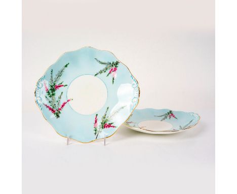 Bone china plates decorated with pink and yellow floral plants on blue ground with gilded scalloped edge. Foley Bone China ba