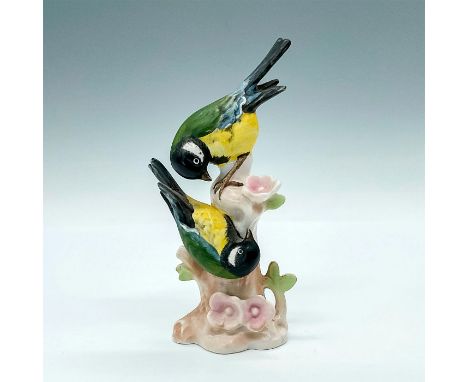 Hand painted figurine of two green and yellow birds playing on a pale flowering tree stump. Goebel sticker and backstamp. Iss