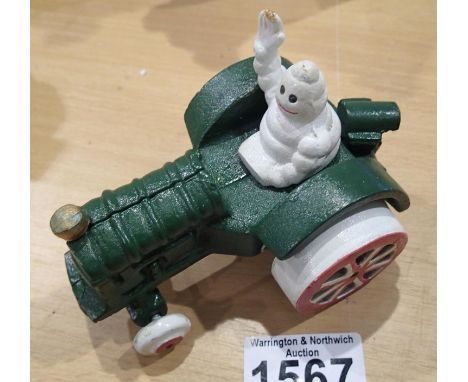 Cast Iron Michelin man in tractor, H: 90 mm. P&amp;P Group 1 (£14+VAT for the first lot and £1+VAT for subsequent lots) 