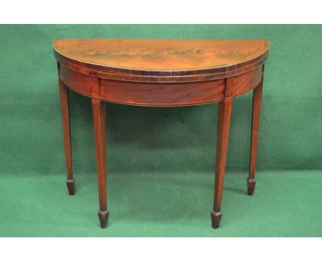 Mahogany demi lune fold over card table having cross banded top, the top opening to reveal green baize lined playing surface,