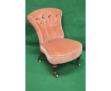 Victorian button back nursing chair having shaped back over upholstered padded shaped seat with bow front, standing on turned