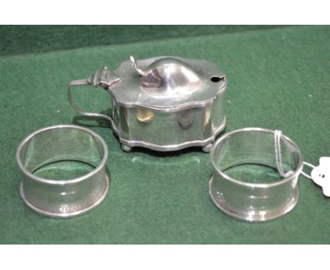 Pair of circular silver napkin rings with engine turned decoration, marked for Birmingham 1960 and a silver mustard pot with 