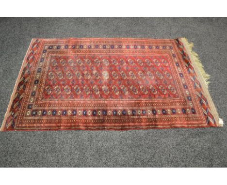 Red ground carpet having blue, white and orange pattern - 75" x 48.5"