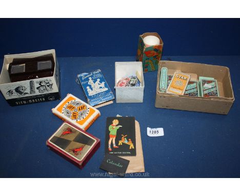 A box of miscellanea including old playing cards, old Viewmaster and six packets of old cigarette Cards