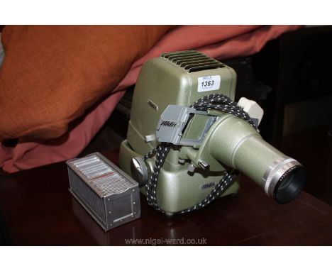 An Aldis Slide Projector together with a small magazine containing slides, landscapes, etc