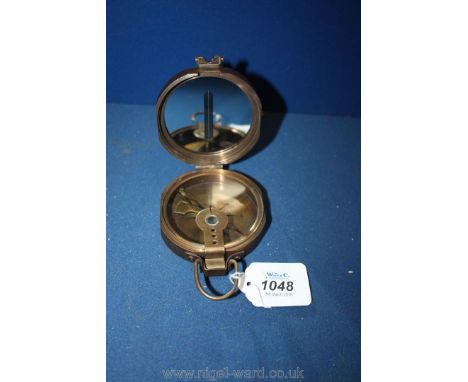 A bronzed, cased Marching Compass marked T. Cooke & Sons, England.