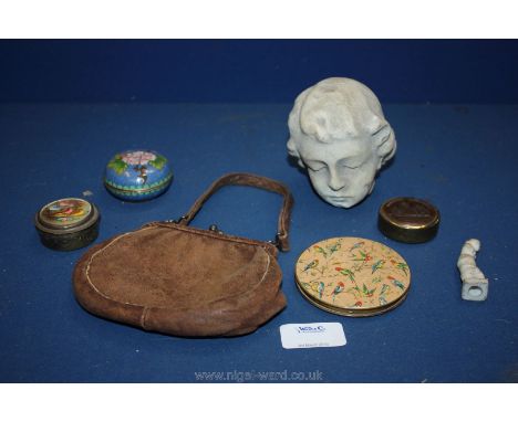 A small leather purse, compact and a carved marble head from a statue