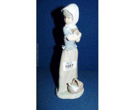 A Nao figure of a Child holding a puppy, 8 3/4" tall