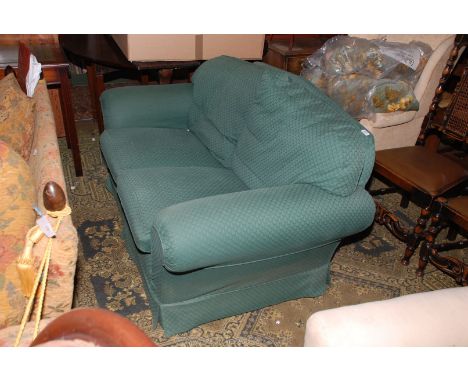 A modern two seater Sofa in green geometric shadow pattern fabric upholstery.