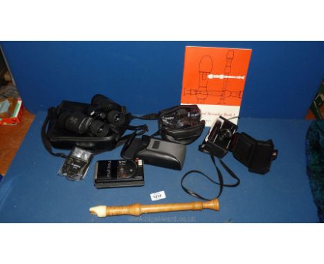 A cased Bushnell pair of Binoculars, cased Kodak 56x Instamatic Camera, new Franka NX-40 cased Camera and flash, and a wooden