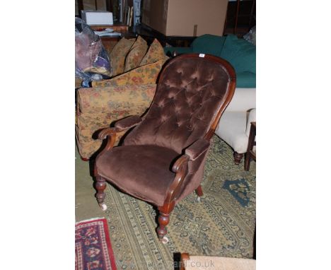 A Victorian Mahogany show frame, hoop and button back Salon Armchair having scroll end arms, on turned legs with ceramic cast