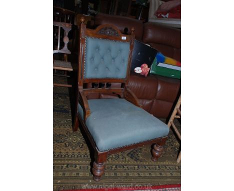 A 19th c. Walnut show frame salon Easy Chair, carved detail, button upholstered back, in pastel blue fabric, standing on turn