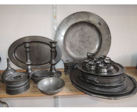 A selection of pewter wares comprising six plates of varying size to include two with pie crust shaped borders, further examp