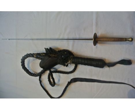A considerable worked black leather whip with further studded detail together with a vintage fencing foil with timber handle 