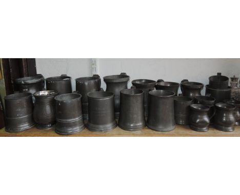 A quantity of twenty pewter tankards ranging from quart size downwards of varying forms and ages to include a 19th century ex
