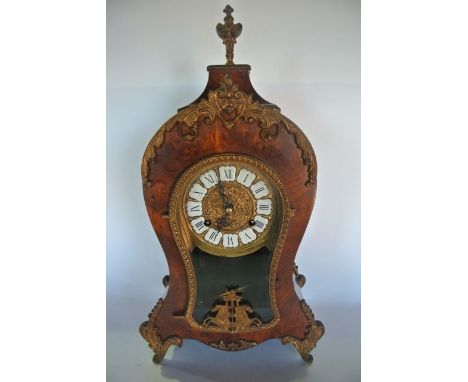 A reproduction French mantle clock in burr walnut case of waisted form with applied cast brass detail and eight day striking 